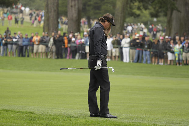 Phil Mickelson reacts after a shot on the ninth hole  
