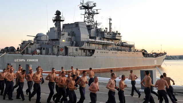 Russian sailors do their morning exercises near a Navy vessel in the bay of the Ukrainian city Sevastopol, the main base of the Russian Black Sea Fleet, Sept. 6, 2011. 