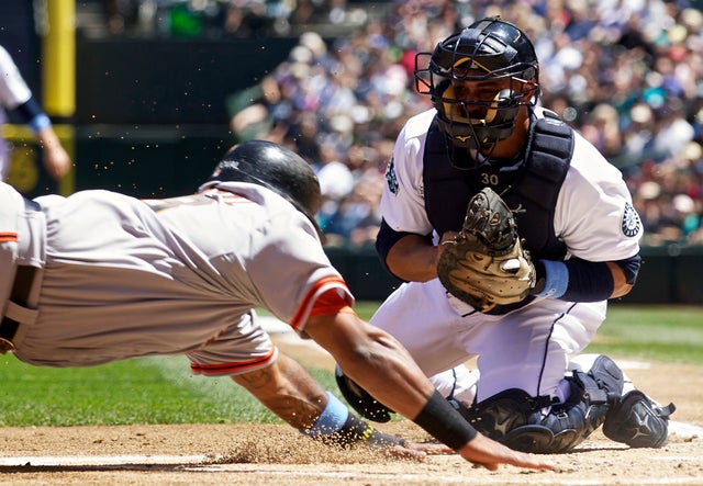 Miguel Olivo attempts to tag out Pablo Sandoval  