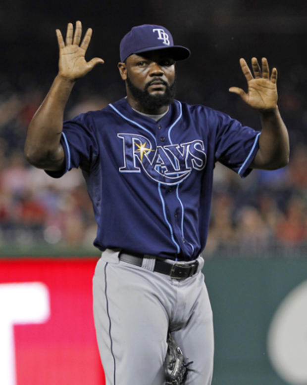 Fernando Rodney removes his glove and holds his hands up  