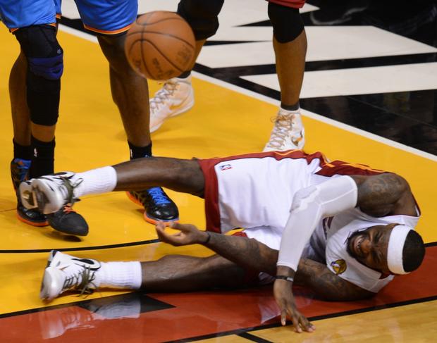 LeBron James of the Miami Heat takes a tumble  