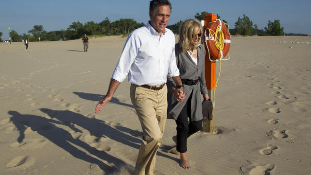 Mitt Romney, left, takes a walk with his wife Ann 