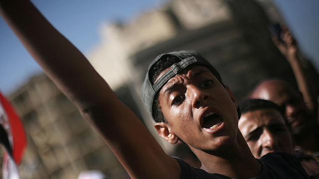 An Egyptian protester chats anti-Supreme Council for the Armed Forces (SCAF) slogans in Tahrir Square, Cairo, Egypt, June 21, 2012.  