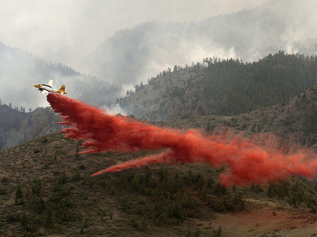 Aircraft drops a load of fire retardant slurry above the High Park wildfire 