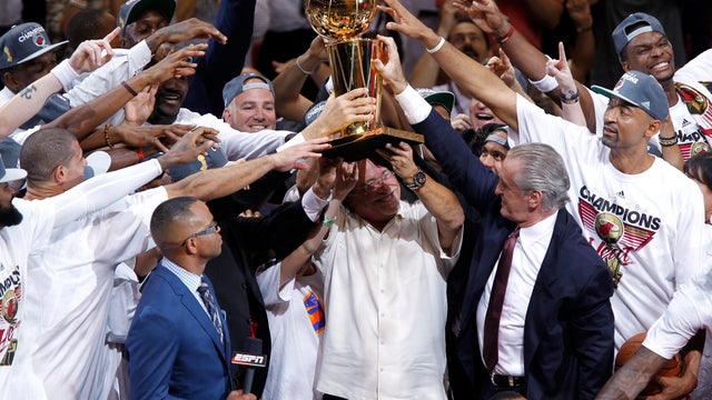 Team owner Micky Arison of the Miami Heat holds up the Larry O'Brien Championship trophy  