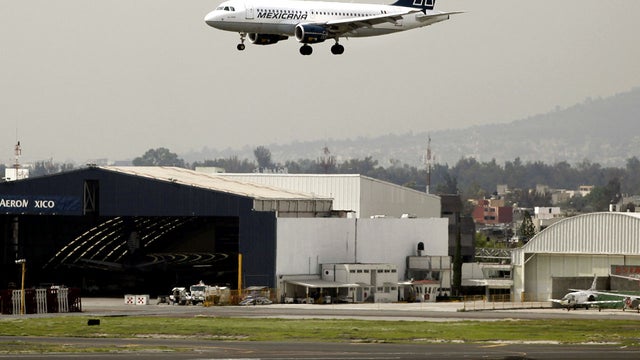 A plane lands at Benito Juarez International Airport in Mexico City. 