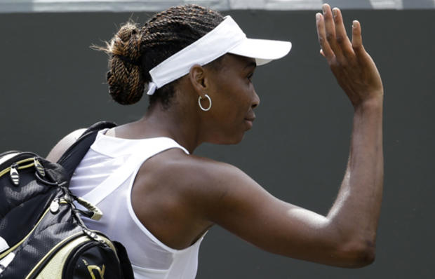 Venus Williams waves to fans after being defeated by Elena Vesnina  