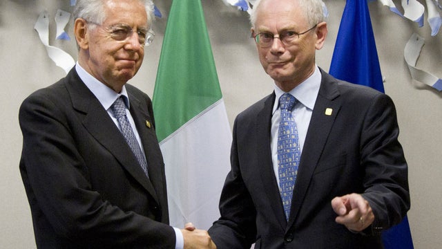 Italian Prime Minister Mario Monti, left, shakes hands with European Council President Herman Van Rompuy during a meeting prior to an EU Summit in Brussels on Thursday, June 28, 2012.  