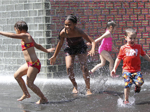 Children enjoy the cool water on a hot summer day at Crown Fountain in Chicago's Millennium Park on Wednesday, June 27, 2012. Temperatures in Illinois are forecast to top 100 degrees by Thursday, and authorities are urging the public to be cautious. 