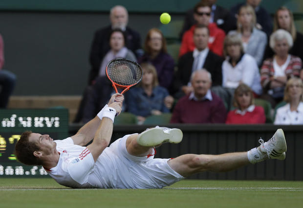 Andy Murray struggles to try and return a shot to Marcos Baghdatis 