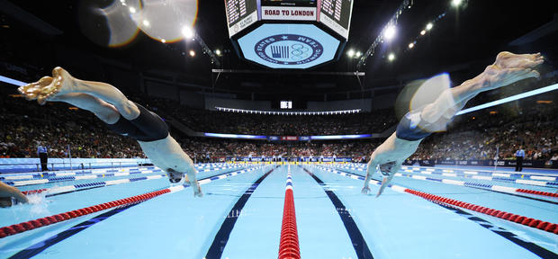 Davis Tarwater, left, and Michael Phelps dive at the start of men's 100-meter butterfly  
