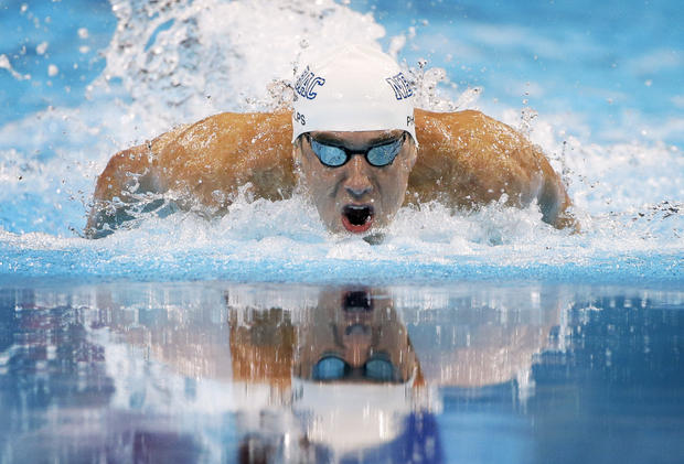 Michael Phelps swims to victory in the men's 100-meter butterfly  