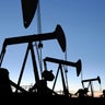 oil pumpjacks in silhouette at twilight 
