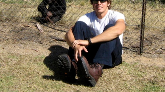 Graduate student Andrew Oberle sits with a chimp in this undated photo provided by the Facebook group HelpAndrewOberle. 