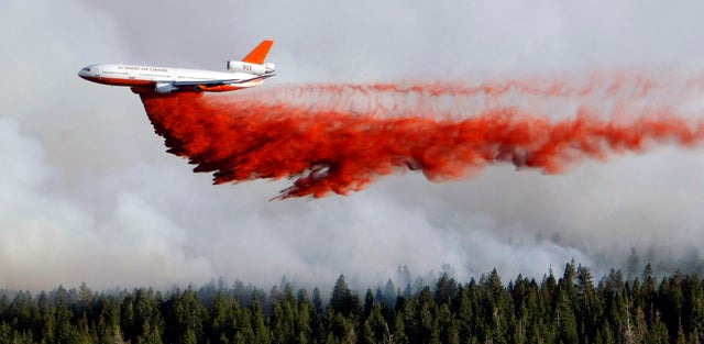 A heavy tanker drops retardant as crews battle the Shingle Fire  