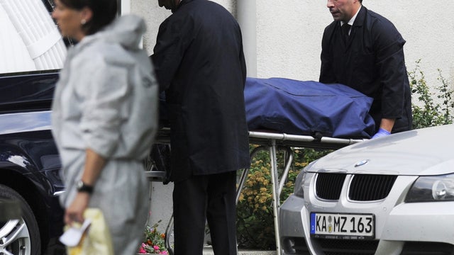 A body is moved from a house in Karlsruhe , Germany, after a hostage-taking Wednesday July 4, 2012. 