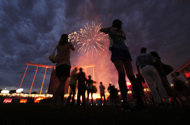 Players watch the fireworks after the MLB All-Star celebrity softball game 