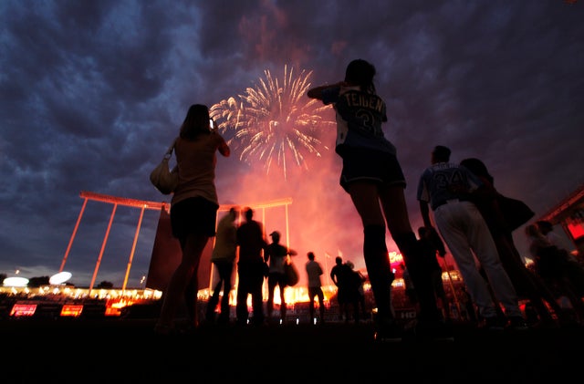 Players watch the fireworks after the MLB All-Star celebrity softball game 
