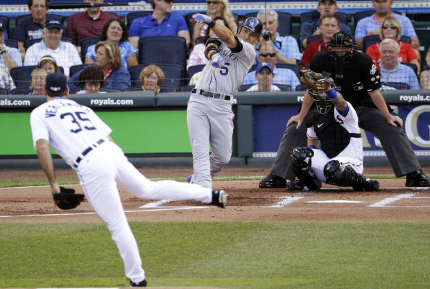 Carlos Gonzalez loses his bat as he swings on a pitch 