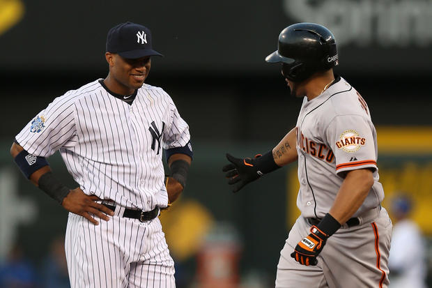 Melky Cabrera  attempts to give a five to Robinson Cano 