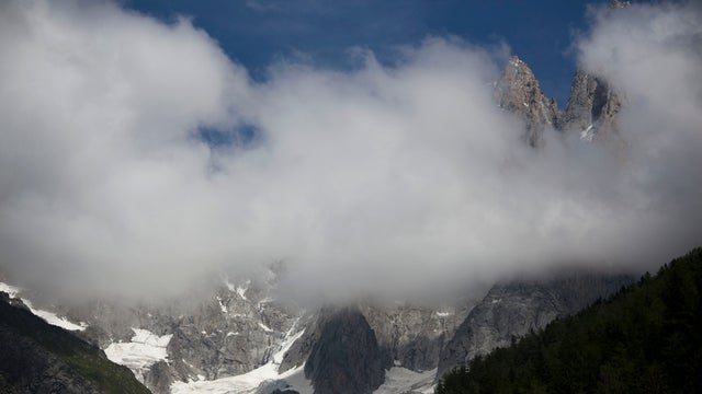 Clouds billow over the French Alps where an avalanche in the mountains near Chamonix, France, swept at least nine climbers to their deaths, Thursday, July 12, 2012. About 28 climbers from Switzerland, Germany, Spain, France, Denmark and Serbia were believ 