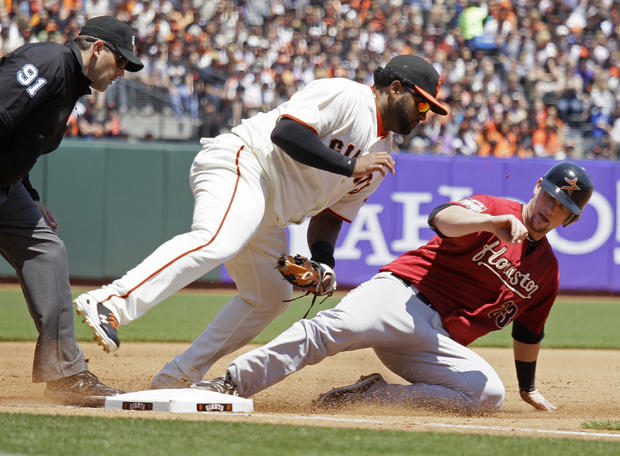 Chris Johnson is tagged out at third base by Pablo Sandoval 