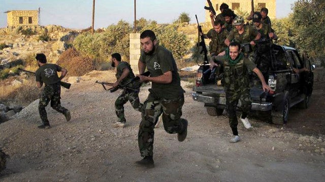 Free Syrian Army soldiers run for cover in Idlib, Syria, in this citizen journalism image taken July 13, 2012, and provided by Edlib News Network ENN. 