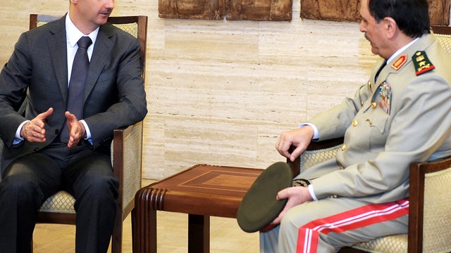 Syrian President Bashar Assad, left, meets with Fahd Jassem al-Freij, the country's new defense minister, July 19, 2012, in this photo released by the Syrian official news agency SANA. 