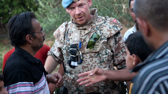 Syrian men give witness accounts in the central province of Hama July 13, 2012, to Danish Lt. Col. Peter Dahl, a United Nations observer team member. 