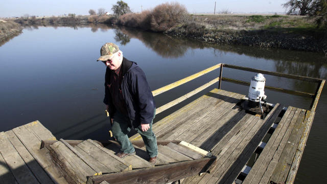 Farmer Mike Robinson is seen after inspecting a pump used to draw water from the San Joaquin River to irrigate his family farm in the Sacramento-San Joaquin Delta near Stockton, Calif., Jan. 16, 2009. 
