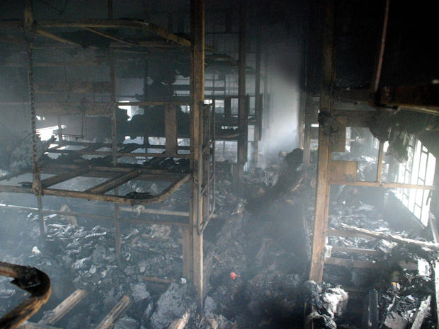 A totally charred coach from inside is seen of a passenger train 