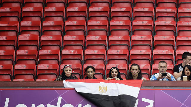 Spectators sit among empty seats before Egypt's group C men's soccer match against New Zealand at London Games Sunday 