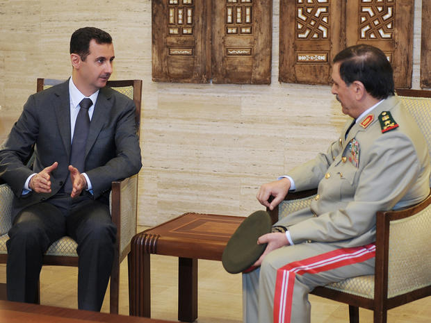 Syrian President Bashar Assad, left, meets Fahd Jassem al-Freij, Syria's new Defense Minister 
