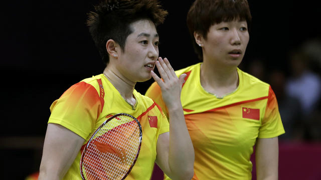 China's Yu Yang, left, and Wang Xiaoli talk during a doubles badminton match 