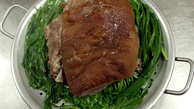 Boiled dog meat is prepared in the kitchen at a restaurant in Gwacheon, South Korea, July 5, 2005. 