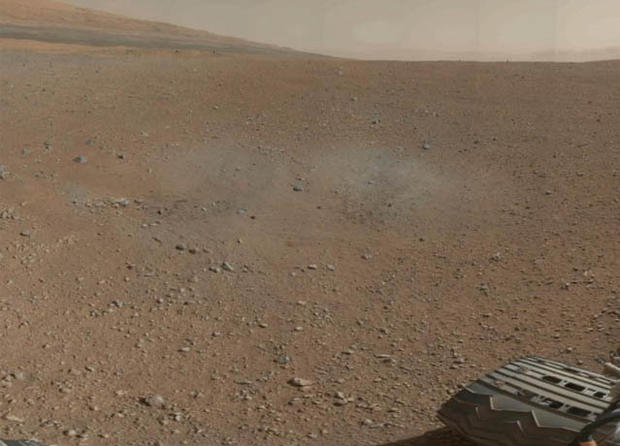 Scorch marks left by Curiosity's landing rockets are clearly visible in the color image that also shows the rim of Gale Crater. 