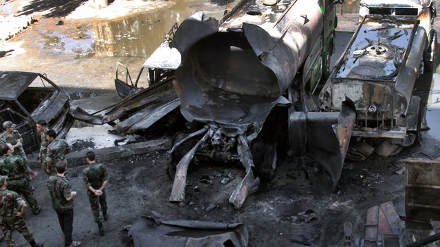 Syrian security investigate after a bomb attached to a fuel truck exploded outside a hotel 