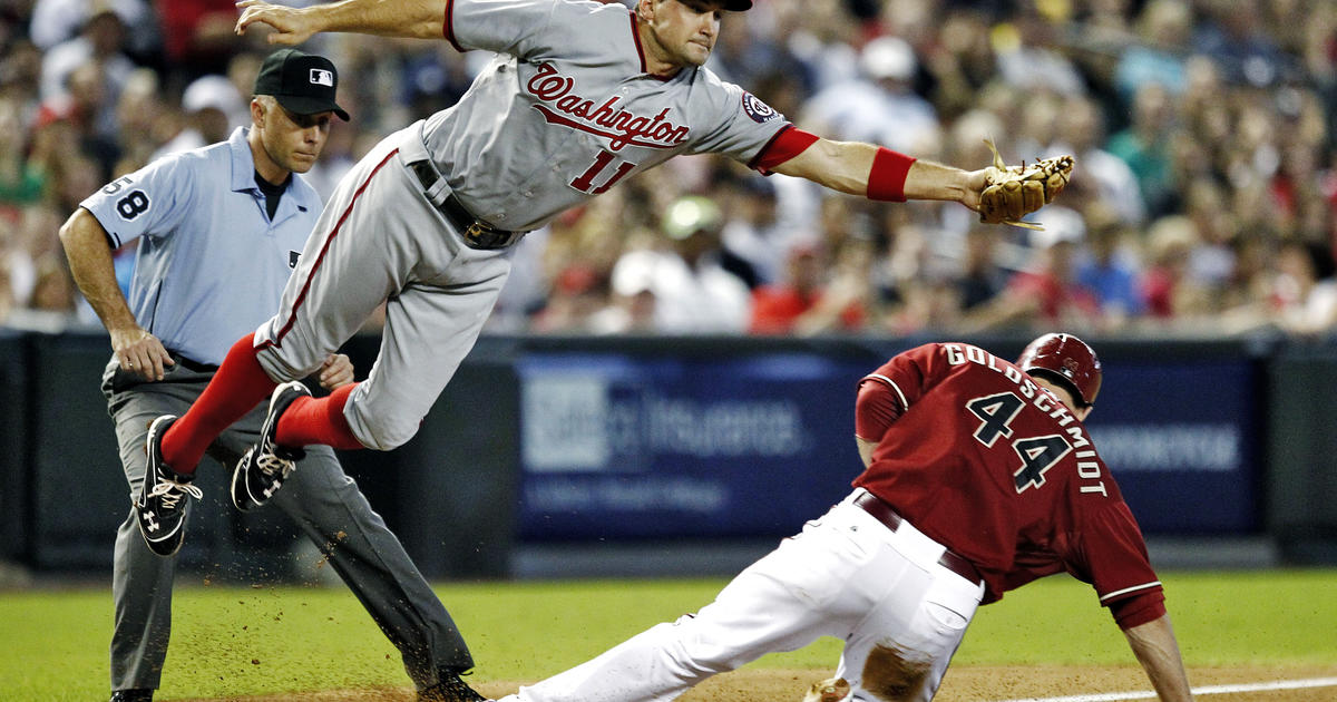 Chicago Cubs' Darwin Barney (15) is safe at first as Cincinnati