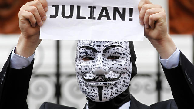 A supporter of WikiLeaks founder Julian Assange holds up a placard outside the Ecuadorian Embassy in London Aug. 16, 2012. 