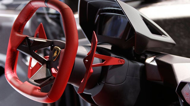 This image shows the dashboard cluster and steering wheel of the Lamborghini Sesto Elemento concept car 