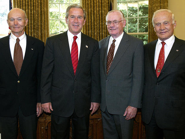 President George W. Bush greets the astronauts of Apollo 11, Neil Armstrong, center-right, Edwin "Buzz" Aldrin, right, and Michael Collins, left, in the Oval Office at the White House in Washington July 21, 2004, 35 years after Armstrong and Aldrin were t 