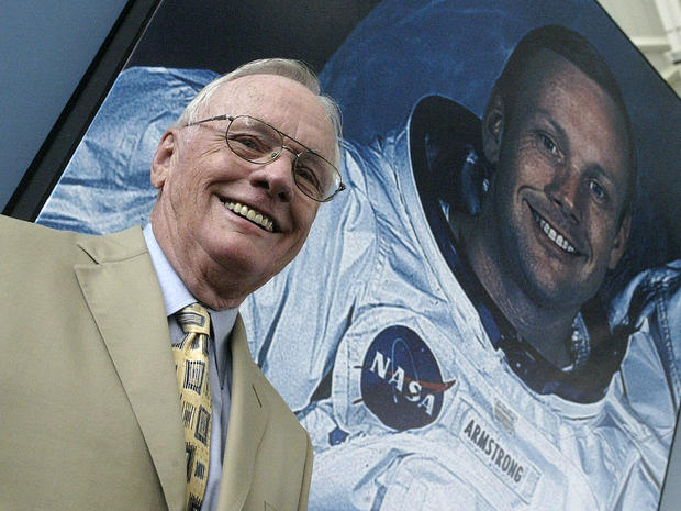 Apollo 11 astronaut Neil Armstrong poses in front of his photo during a visit to the Prince Felipe Museum in Valencia, Spain, July 26, 2005. 