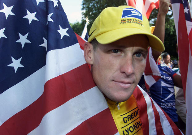 Lance Armstrong holds his national flag 