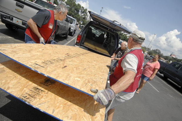 Lowes employees  load plywood 