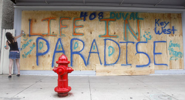 Shira Edllan Gervasi puts her name on plywood protecting a storefront in Key West 