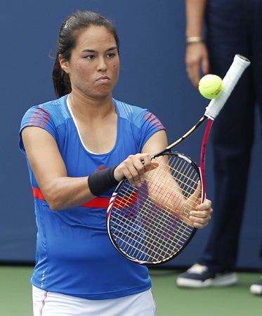Jamie Hampton hits a ball with the handle of her racket 