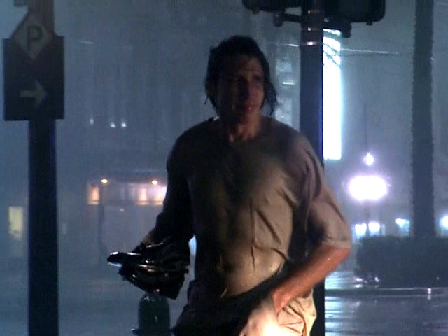 A man carries his shoes in New Orleans as Hurricane Isaac pounds the city Aug. 29, 2012. 