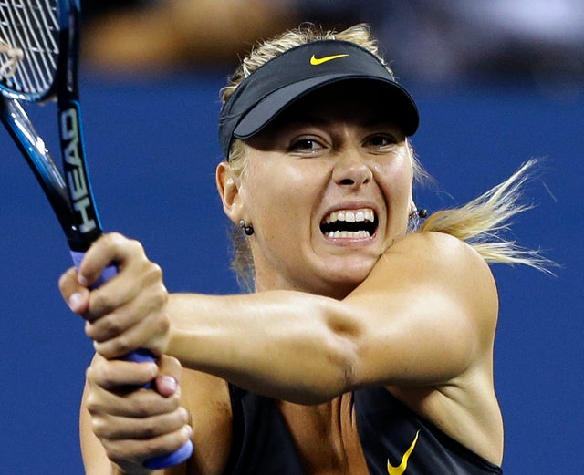 Maria Sharapova returns a shot to Lourdes Dominguez Lino 