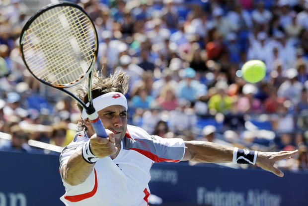 David Ferrer reaches for the ball  