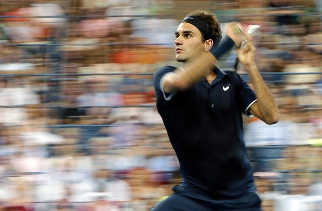 Roger Federer returns a shot to Bjorn Phau 